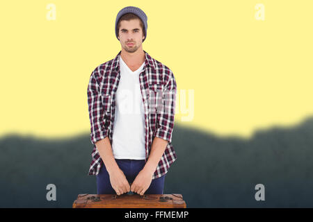 Image composite de young man holding bag Banque D'Images