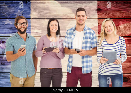 Image composite de portrait of smiling business people using electronic gadgets Banque D'Images