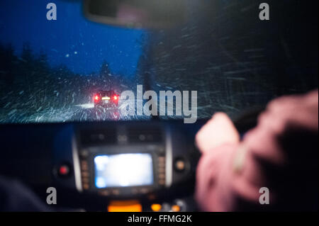 L'homme conduit une voiture dans la neige dans l'Aberdeenshire, en Écosse. Banque D'Images