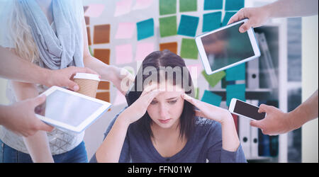 Image composite de déprimé businesswoman with head in hands Banque D'Images