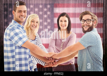 Image composite de portrait of smiling business people mettant leurs mains ensemble Banque D'Images