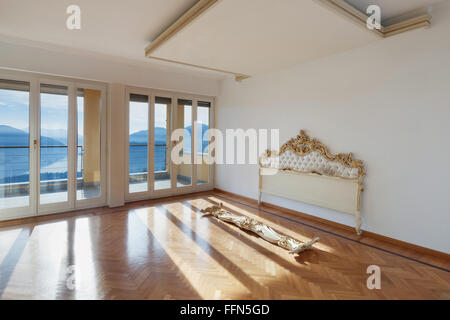 L'intérieur d'une chambre, salle vide avec tête, parquet et murs blancs Banque D'Images