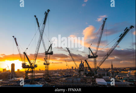 Grues à tour sur la nouvelle Place Bloomberg office développement dans la ville de London, EC4 qui se profile à l'horizon au coucher du soleil Banque D'Images