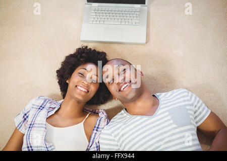 Heureux couple lying on the floor Banque D'Images