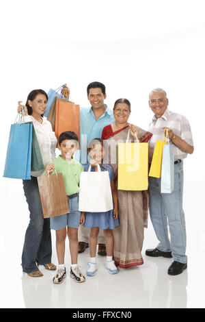 Les enfants de parents avec un grand-parent montrant colorful shopping bags M.# 703N, 703o, 703P, 703Q, 703R, 703S Banque D'Images