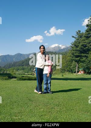 Girl hugging sœur ; parc ; Indira Gandhi Pahalgam ; Jammu-et-Cachemire en Inde ; M.# 477 Banque D'Images