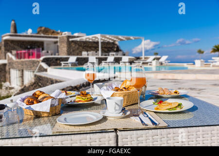 Petit-déjeuner frais et jus, une table à côté de la piscine Banque D'Images