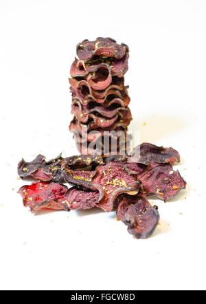 Une pile de chips de betterave ronde fine cuit au four avec l'origan et le sel empilées sur fond blanc. Un sain, végétarien, v Banque D'Images