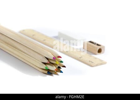 Crayon, gomme, taille-crayon, règle en bois sur fond blanc Banque D'Images