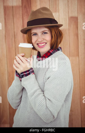 Hipster smiling woman in a hat, tenant un café Banque D'Images