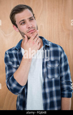 Beau hipster with hand on chin Banque D'Images