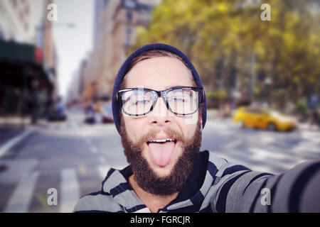 Image composite de portrait of happy hipster sticking out tongue Banque D'Images