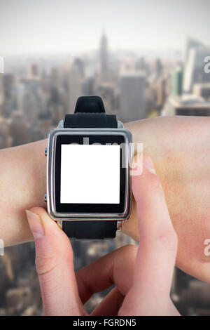 Composite image of woman using smartwatch Banque D'Images