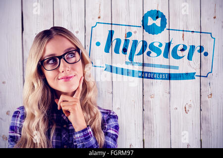 Image composite de gorgeous smiling blonde hipster daydreaming Banque D'Images