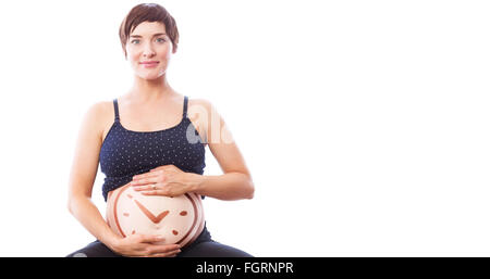 Image composite de portrait of happy pregnant woman holding belly Banque D'Images