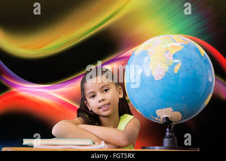 Image composite de cute pupils sitting at desk Banque D'Images