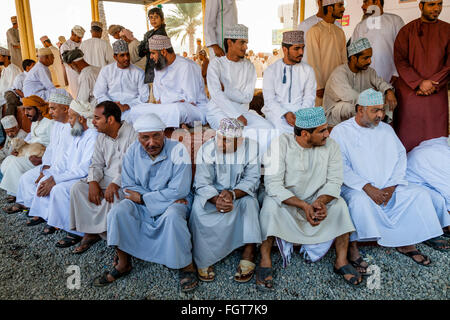 Les hommes en costume traditionnel omanais au marché aux bestiaux de Nizwa, vendredi, Ad Dakhiliyah, Région de l'Oman Banque D'Images