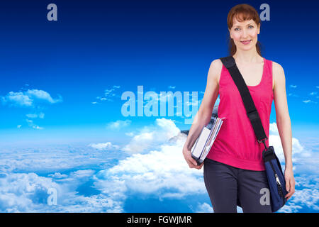 Image composite de woman holding her school notebooks Banque D'Images