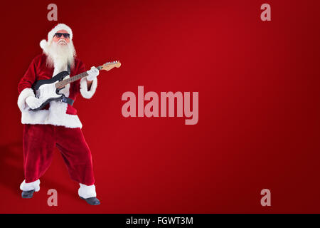 Image composite de santa claus joue de la guitare avec des lunettes Banque D'Images