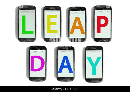 Leap Day écrit sur les écrans de smartphones photographié sur un fond blanc. Banque D'Images