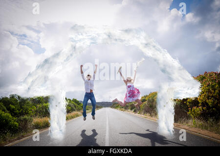 Image composite de l'heureux couple jumping on the road Banque D'Images