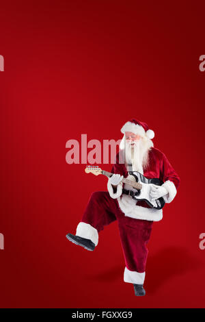 Image composite du père Noël a l'amusement avec une guitare Banque D'Images