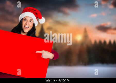 Image composite de woman pointing at sign Banque D'Images