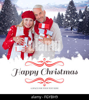 Image composite de l'heureux couple de fête avec des cadeaux Banque D'Images