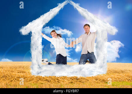 Image composite du couple jumping and holding hands Banque D'Images