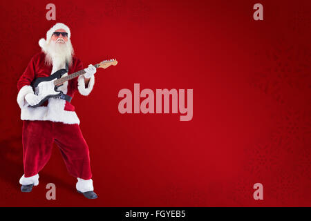 Image composite de santa claus joue de la guitare avec des lunettes Banque D'Images