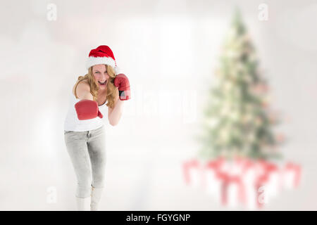 Image composite de blonde de fête avec des gants de boxe boxe Banque D'Images