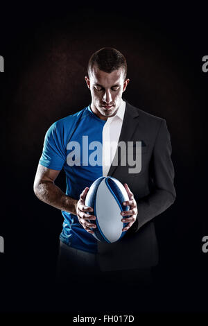 Image composite de rugby player holding ball Banque D'Images