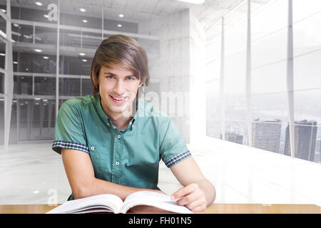 Image composite de student sitting in library reading Banque D'Images