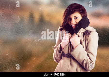 Composite image of Beautiful woman in winter coat Banque D'Images