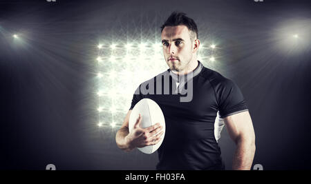 Image composite de difficiles rugby player holding ball Banque D'Images