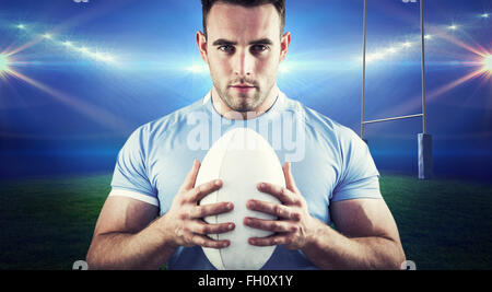 Image composite de rugby player looking at camera with ball Banque D'Images