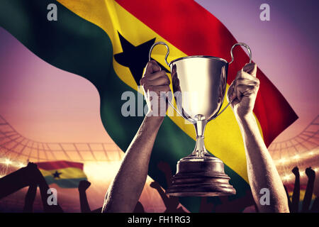 Image composite de rugby player holding trophy Banque D'Images