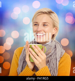 Composite Image de femme à boire dans une tasse Banque D'Images