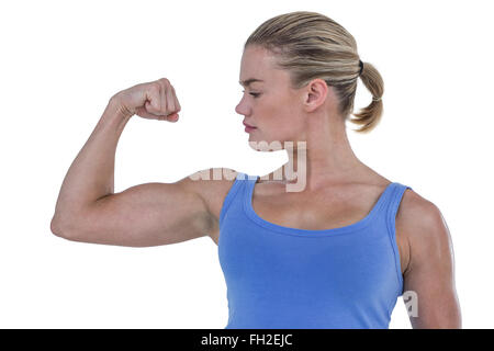 Woman flexing muscles muscle sa Banque D'Images