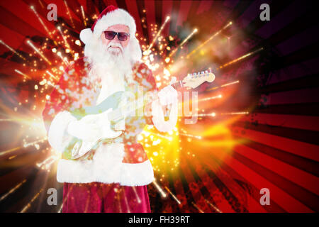 Image composite de santa claus joue de la guitare avec des lunettes Banque D'Images