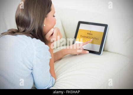 Composite image of woman touching her digital tablet Banque D'Images