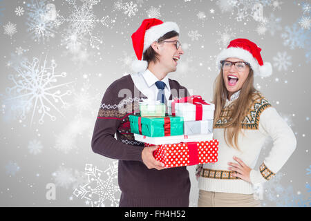 Image composite de hipster geek couple holding presents Banque D'Images