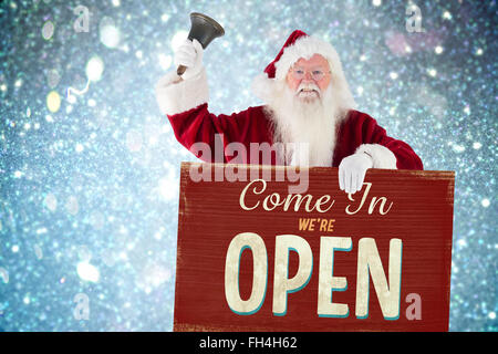 Image composite de santa est titulaire d'un signe et bagues sa bell Banque D'Images
