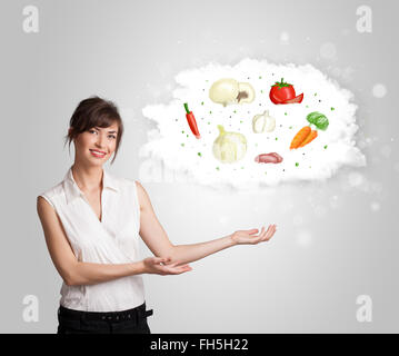 Jolie femme présentant un nuage d'concept légumes Banque D'Images