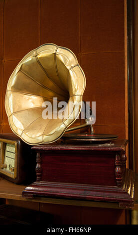 Vieux gramophone avec corps en bois et corne d'or sur fond brun Banque D'Images