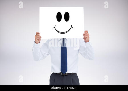 Image composite de commerçant holding blank sign en face de sa tête Banque D'Images