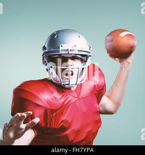 Composite image of american football player throwing ball Banque D'Images