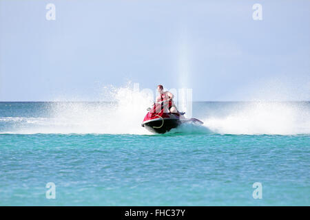 Jeune mec croisière sur un jet ski sur la mer des Caraïbes Banque D'Images