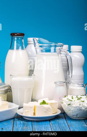 Produits laitiers sains savoureux sur une table, sur un fond bleu Banque D'Images