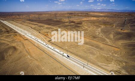 (160228) -- BEIJING, 28 février 2016 (Xinhua) -- File photo prise le 22 mai 2015 montre un bullet train en marche le long d'un 750-KV sur le projet de transmission de puissance Lanzhou-Xinjiang grande vitesse ferroviaire, le nord-ouest de la Chine. "Construire plus de chemins de fer à grande vitesse' a été un sujet chaud à la session annuelle de la législature provinciale et des organismes consultatifs politique intensive tenue en janvier. La Chine dispose du plus grand réseau ferroviaire à grande vitesse, avec la longueur d'exploitation total atteignant 19 000 km d'ici la fin de 2015, environ 60 pour cent du total mondial. L'expansion du réseau ferroviaire à grande vitesse est offeri Banque D'Images